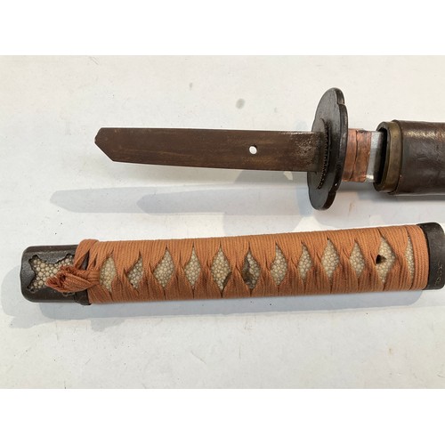 9372 - A Japanese katana, ray skin grip wrapped in cloth, iron tsuba with copper foliage, the tang unsigned... 