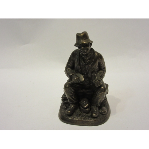 4276 - A bronzed sculpture of a flint knapper, 14cm tall