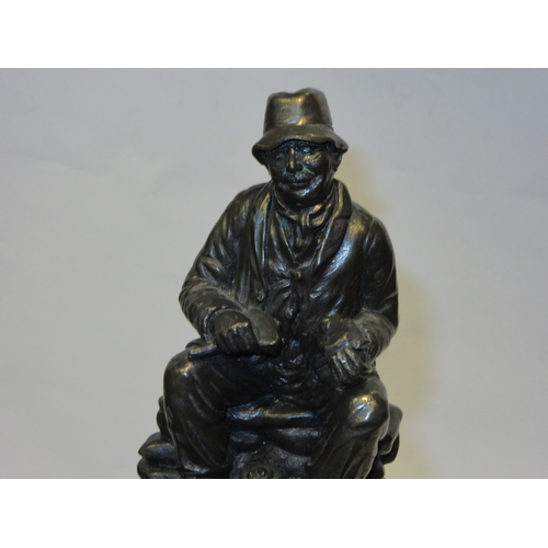 4276 - A bronzed sculpture of a flint knapper, 14cm tall