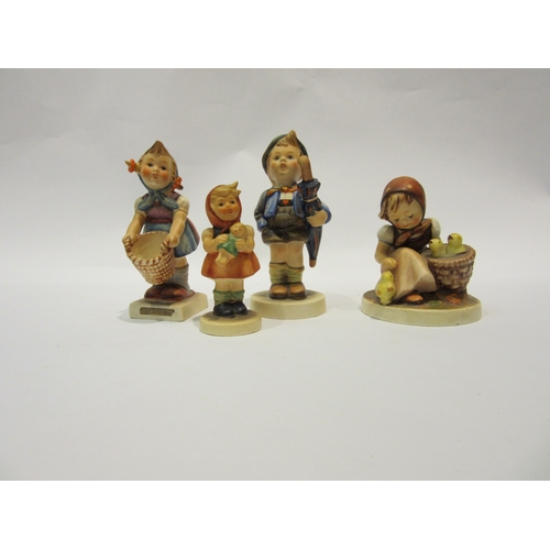 4278 - Four Goebel Hummel figures including boy with pig in basket dated 1948