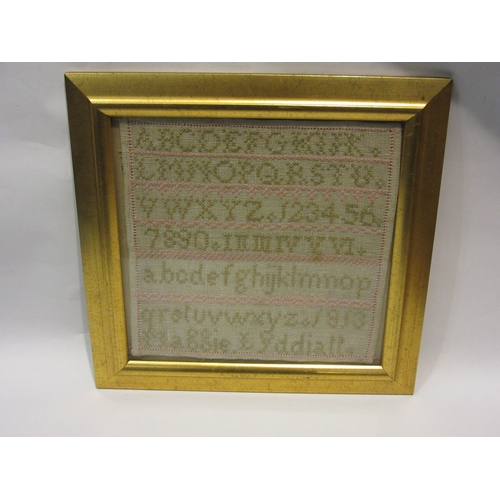 4286 - An alphabetical sampler by Maggie Lydiall 1913, later framed and glazed, 29cm x 29cm image size