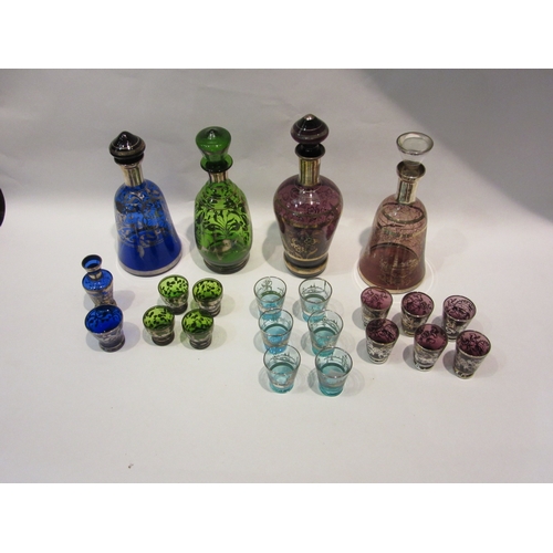 4289 - A collection of Bohemian coloured glass decanters and glasses sets