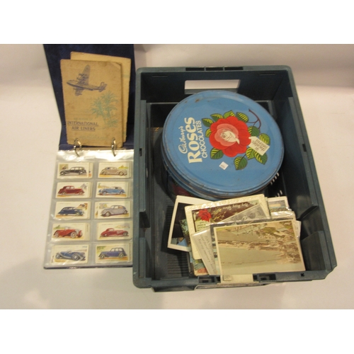 4414 - A box containing a postcard and stamp collection together with a folder of cigarette cards