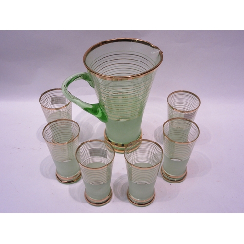 4419 - A 1920's eau de nil coloured glass lemonade set ringed in gilt