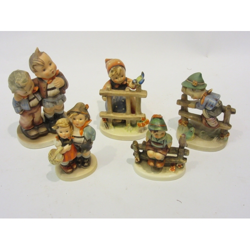 4451 - Five Goebel Hummel figures including boys and girls on fences dated 1938 and 1948, tallest 14cm