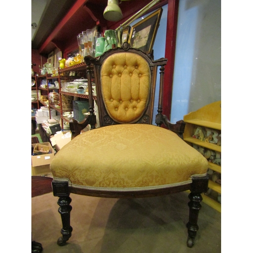 4012 - A Victorian style button back armchair with carved decoration