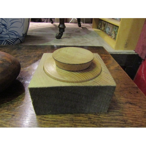 4024 - A burr wood lidded box, a wooden ball on stand with multiple wood types, together with another woode... 