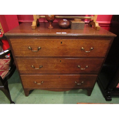 4025 - A 19th Century planked oak chest of three graduating long drawers with brass swan neck handles over ... 