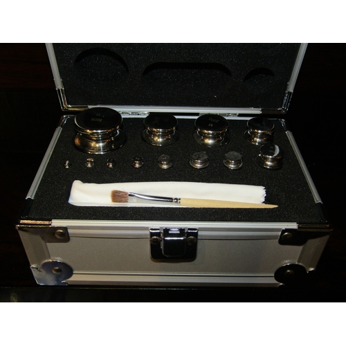 4027 - A cased set of 1g - 500g calibration weights, contains 12 stainless steel weights and a brush