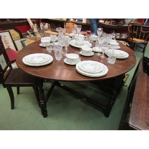 4110 - An 18th Century oak gateleg dining table the rising leaves over a single end cutlery drawer on turne... 