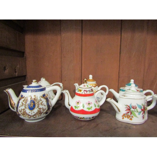 4141 - A collection of Porcelain Art miniature porcelain teapots, mostly floral design (15)