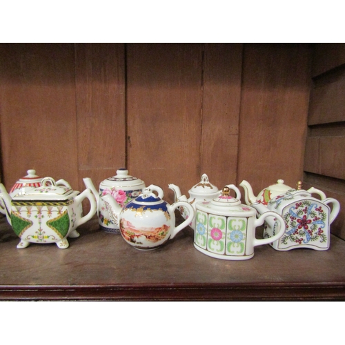 4141 - A collection of Porcelain Art miniature porcelain teapots, mostly floral design (15)