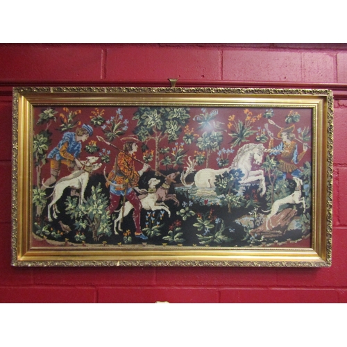 4146 - A 1970's tapestry depicting hunters and dogs wearing jewelled collars after unicorn, framed and glaz... 