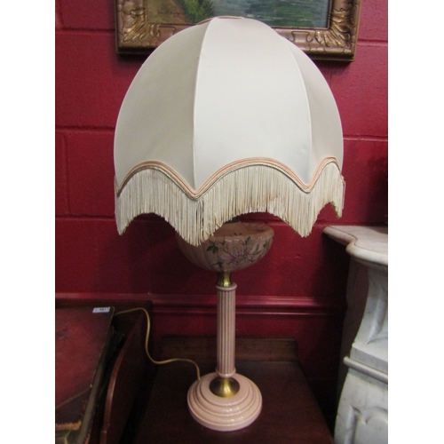 4153 - A pink ceramic column form oil lamp converted into a table lamp with frilled shade