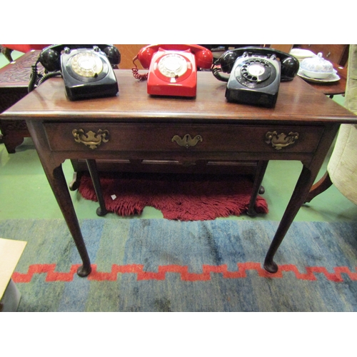 4171 - An early George III oak side table, with long frieze drawer and tapering cylindrical legs to pad fee... 