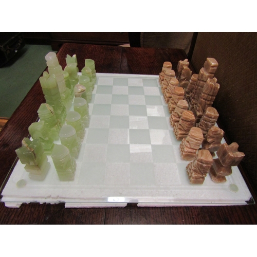 4183 - A glass chess board with onyx pieces