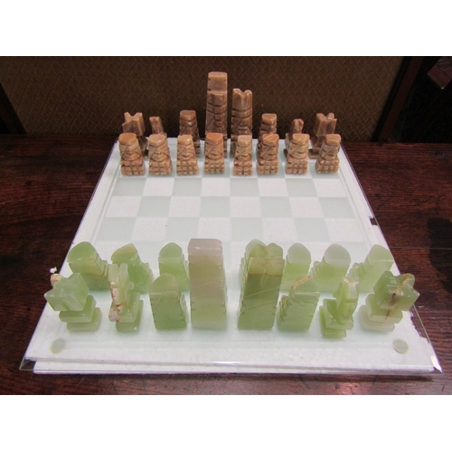 4183 - A glass chess board with onyx pieces