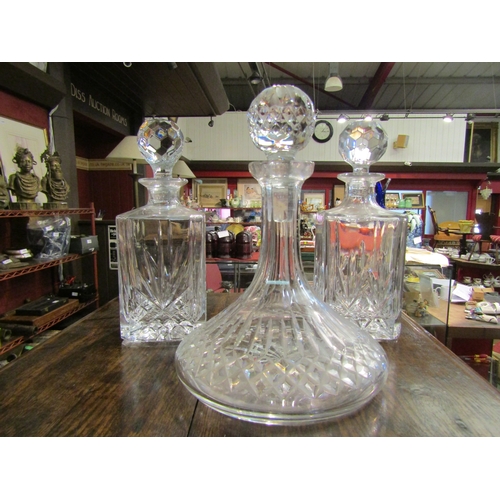 4241 - Two crystal spirit decanters together with a crystal ships decanter (3)