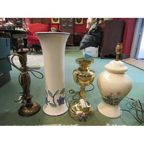 4250 - A group of lamps, one being a converted brass oil lamp with glass shade