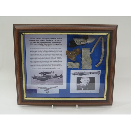 9154 - A framed display of German Luftwaffe ME110 crash items with research