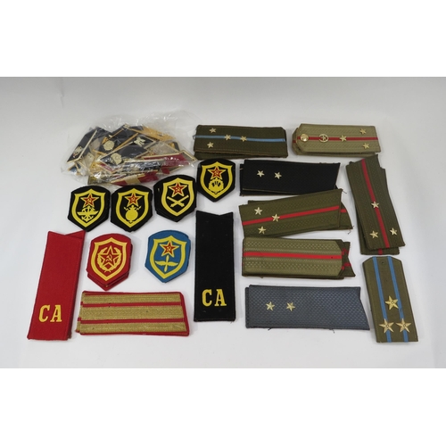 9162 - A collection of Cold War era Russian Soviet USSR insignia including shoulder boards, patches etc