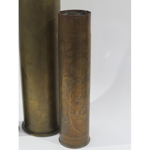 9210 - A WWI trench art brass shell case, a German 105mm shell case and another (3)