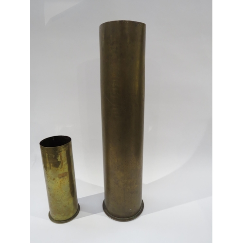 9210 - A WWI trench art brass shell case, a German 105mm shell case and another (3)