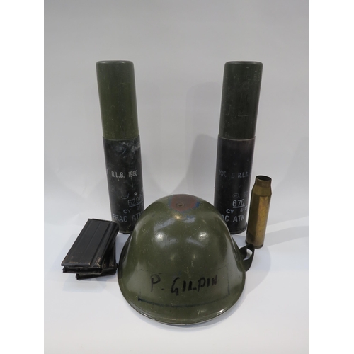 9215 - A post war British army helmet together with two post war practice shells, another and two magazines... 