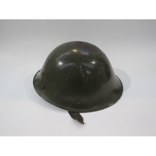 9215 - A post war British army helmet together with two post war practice shells, another and two magazines... 