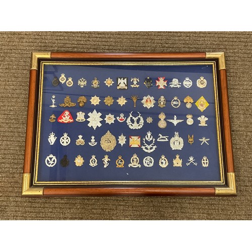 9033 - A collection of approximately 60 staybrite badges, framed and glazed