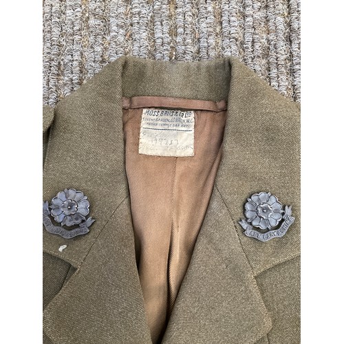 9041 - A WWII officer's jacket to a Lieutenant in the East Lancs Regt. named and dated 1944 with insignia