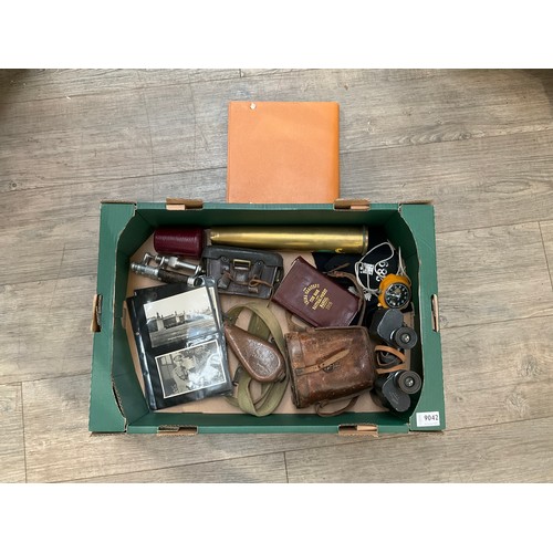 9042 - A box of miscellaneous militaria including shell case, binoculars etc