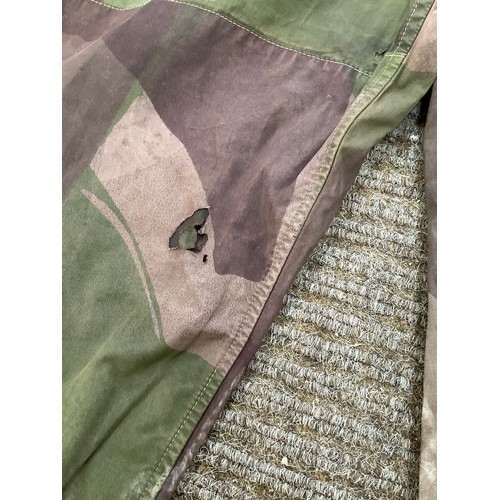 9051 - A pair of WWII 1944 dated British camouflage windproof trousers, some holing