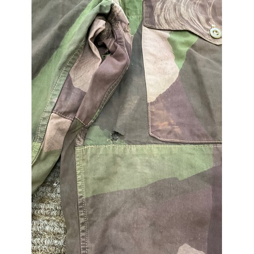 9051 - A pair of WWII 1944 dated British camouflage windproof trousers, some holing