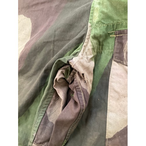 9051 - A pair of WWII 1944 dated British camouflage windproof trousers, some holing