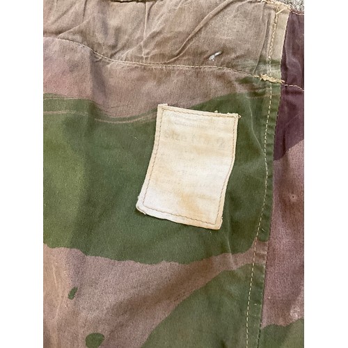 9051 - A pair of WWII 1944 dated British camouflage windproof trousers, some holing