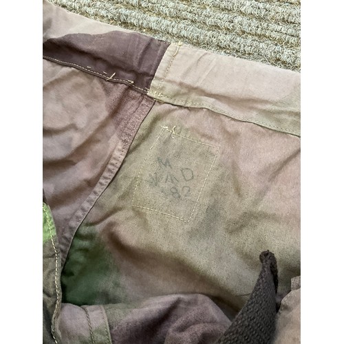 9051 - A pair of WWII 1944 dated British camouflage windproof trousers, some holing