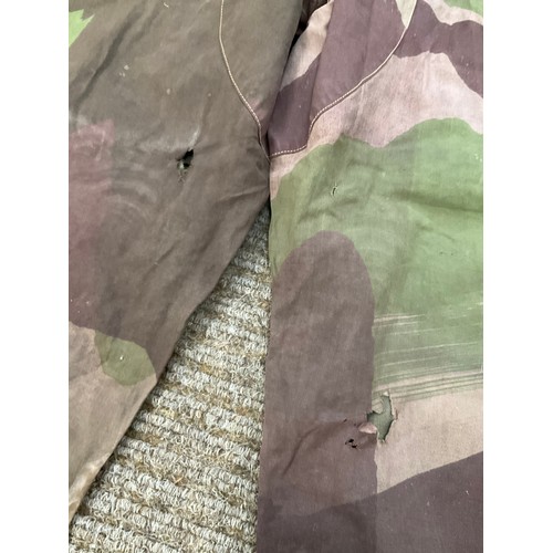 9051 - A pair of WWII 1944 dated British camouflage windproof trousers, some holing