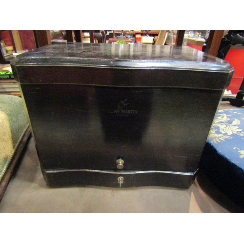 4216 - A 'Remy Martin' cognac table-top decanter cabinet with mirror back and key