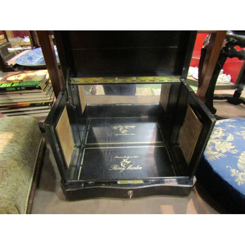 4216 - A 'Remy Martin' cognac table-top decanter cabinet with mirror back and key