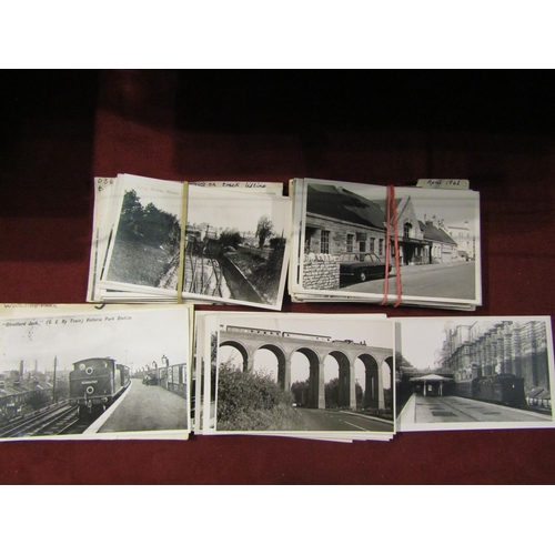 4335 - A selection of vintage black and white railway station photos, an album of transport postcards and t... 