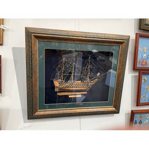 9064 - A framed display of a model of HMS Victory, with a fragment of oak 'Salvaged from HMS Victory', 62cm... 