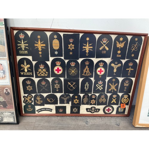 9074 - A framed and glazed display of Royal Naval insignia