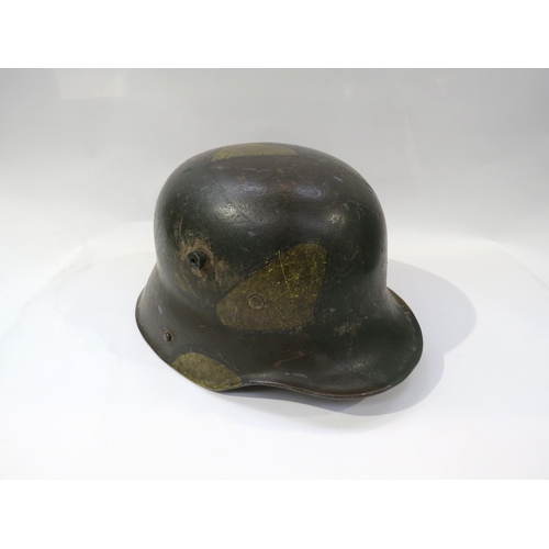 9194 - A reproduction WWI German 1916 Pattern camouflage helmet with replacement liner