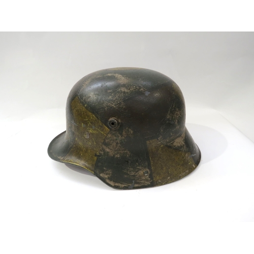 9194 - A reproduction WWI German 1916 Pattern camouflage helmet with replacement liner