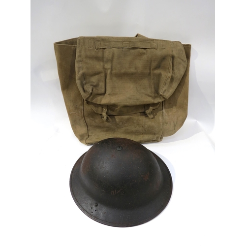 9203 - A WWII British Army helmet dated 1941, together with a WWII webbing kit bag (2)