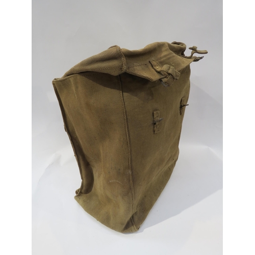 9203 - A WWII British Army helmet dated 1941, together with a WWII webbing kit bag (2)