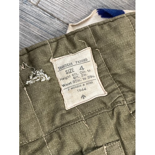 9087 - A pair of WWII British padded cold weather trousers, size 4, dated 1944, by Morris, slight ink stain... 