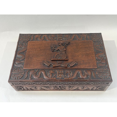 9386 - NORFOLK REGIMENT INTEREST: A Norfolk Regiment carved hardwood box, central crest with scroll, border... 