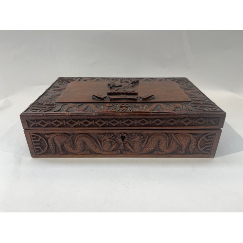 9386 - NORFOLK REGIMENT INTEREST: A Norfolk Regiment carved hardwood box, central crest with scroll, border... 